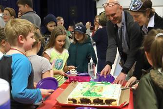 FMS Principal & Students cut the cake at the Blizzard of Books Winter Celebration