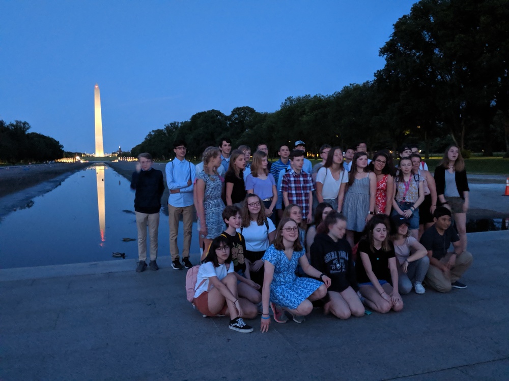 Students on the mall at dusk visiting monuments