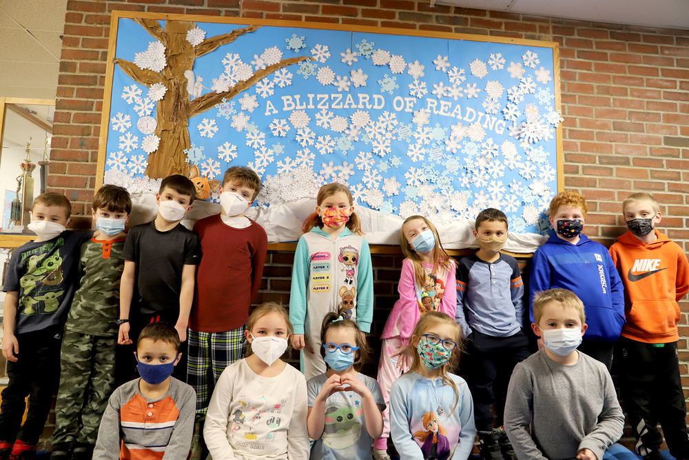 Photo: Kaitlin Woodbury’s 1st grade class in front of the Blizzard of Books bulletin board.