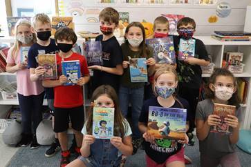 students holding books