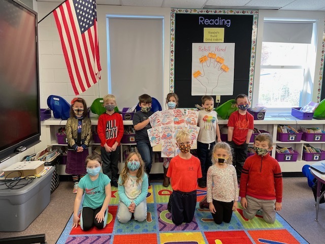 Mrs. Tardif's class holds up the artwork they did for our Veterans!