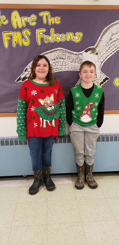 students dressed in ugly holiday sweaters