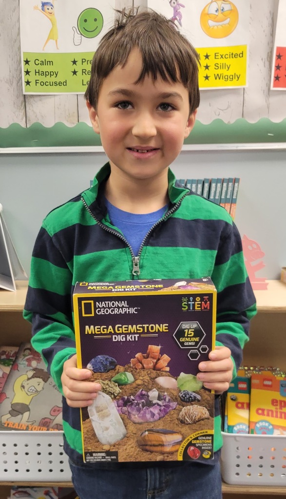 young boy holding mega gemstone STEM kit