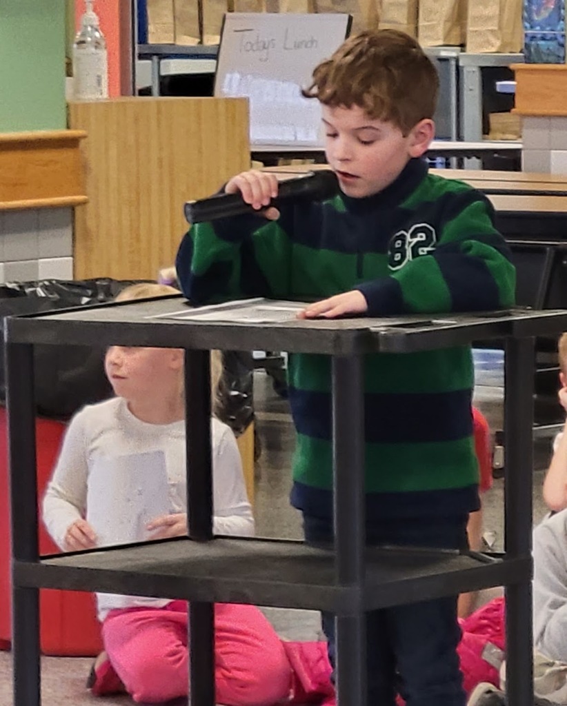 boy reading poetry with a microphone