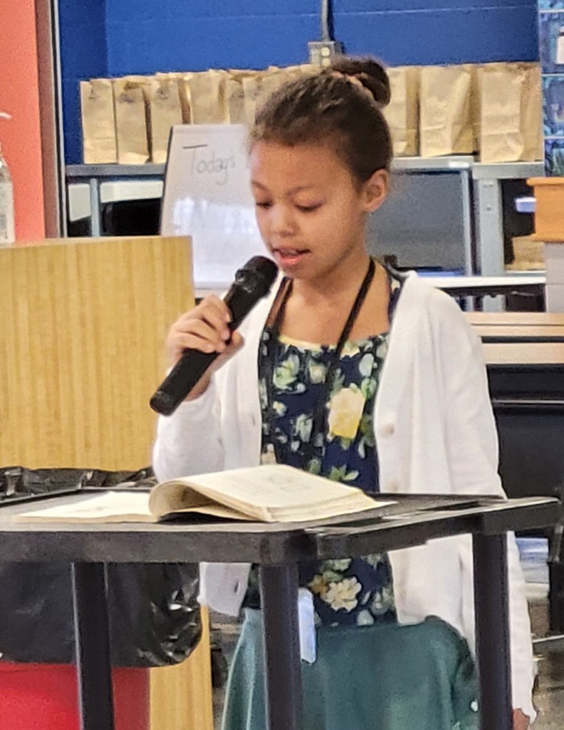 girl reading poetry with a microphone