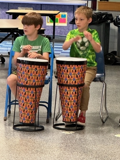 two students playing drums